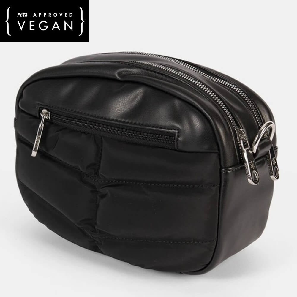 Black vegan leather bag with zippers on a white background, featuring PETA-approved label.