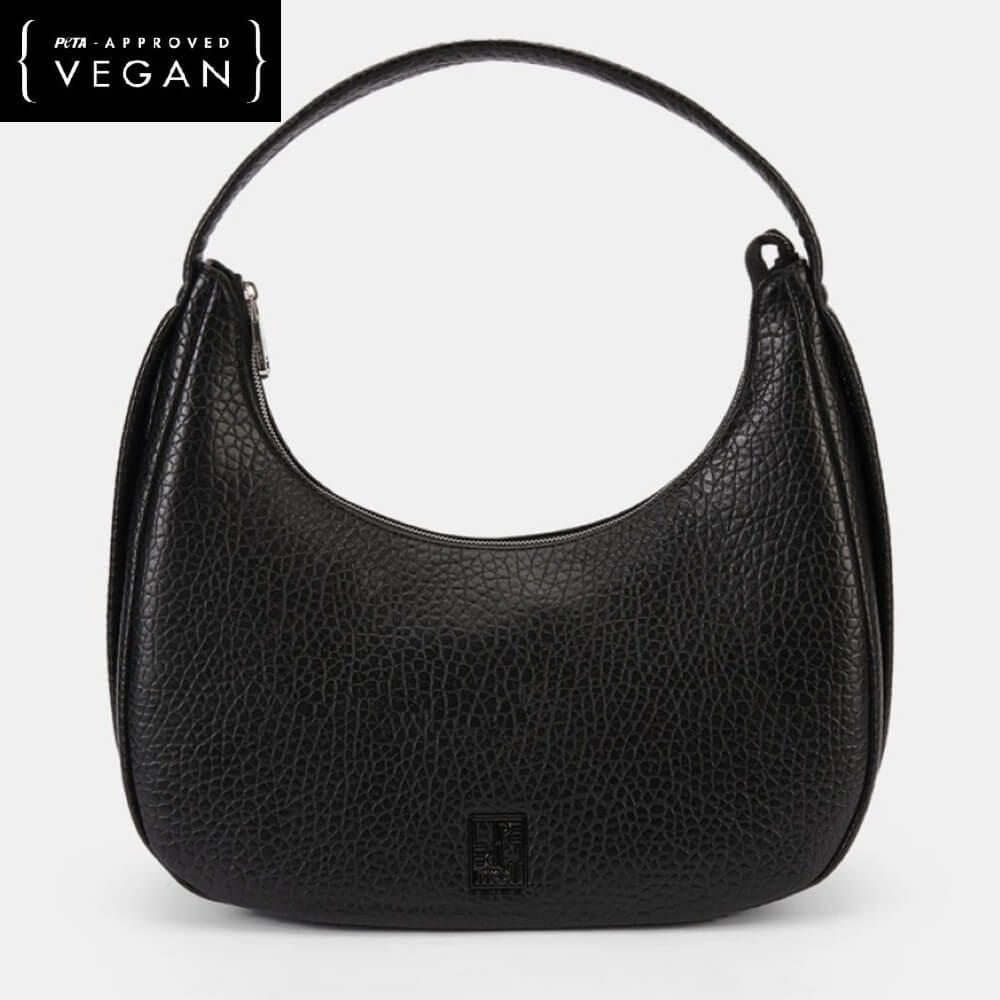 Black vegan handbag on a light gray background with 'Vegan' label.