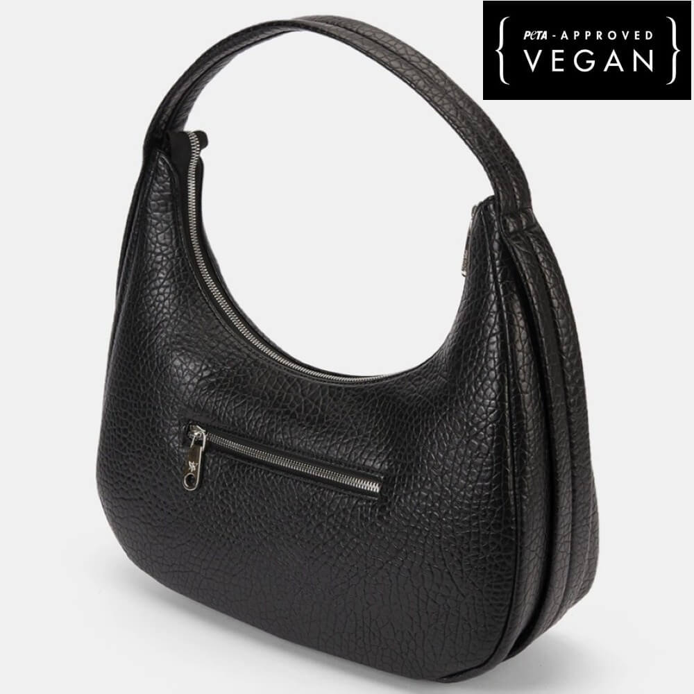 Black handbag with a visible zipper on a white background, featuring a PETA-approved Vegan label.