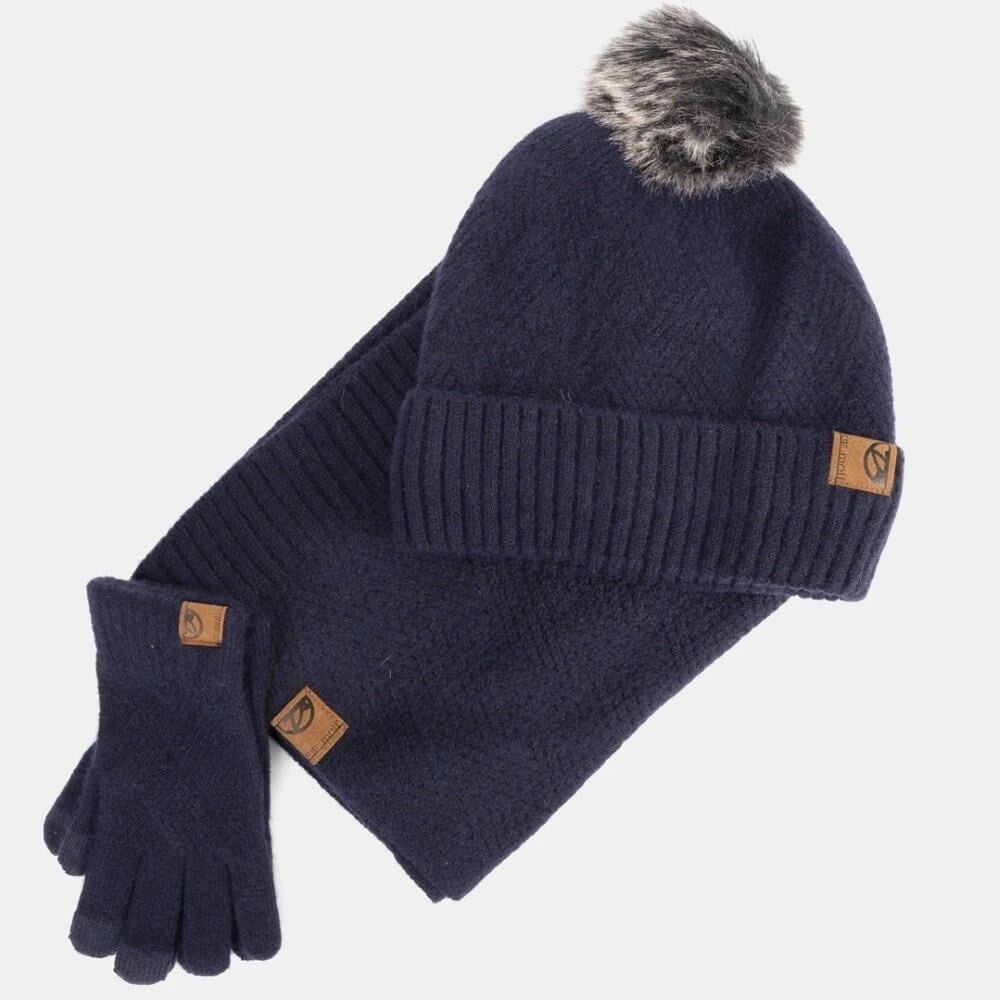 Navy blue knit hat with pom-pom and matching gloves on a light gray background