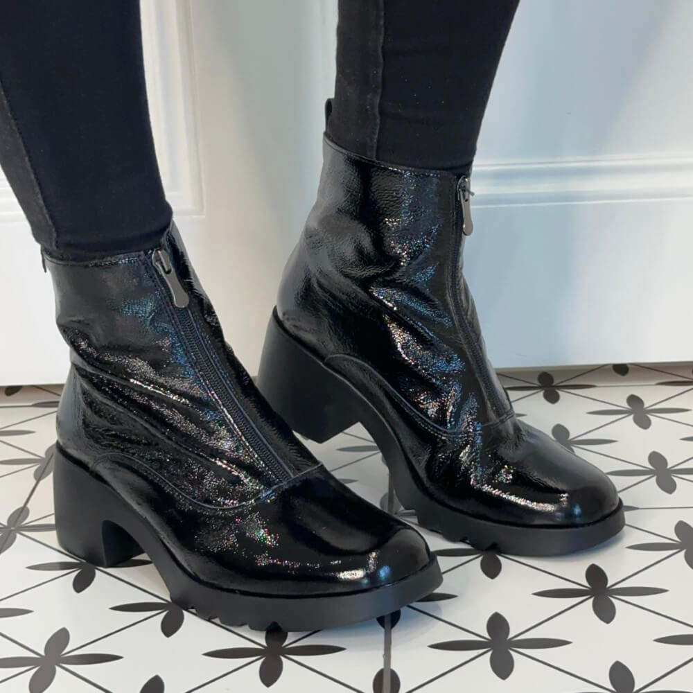 Black patent ankle boots worn with black pants on a tiled floor. Pepe Saenz Ladies Boot 21225 Black