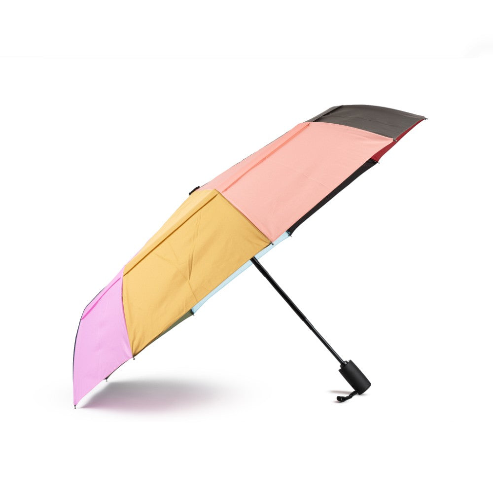 Colorful umbrella with pink, yellow, and black sections on a white background