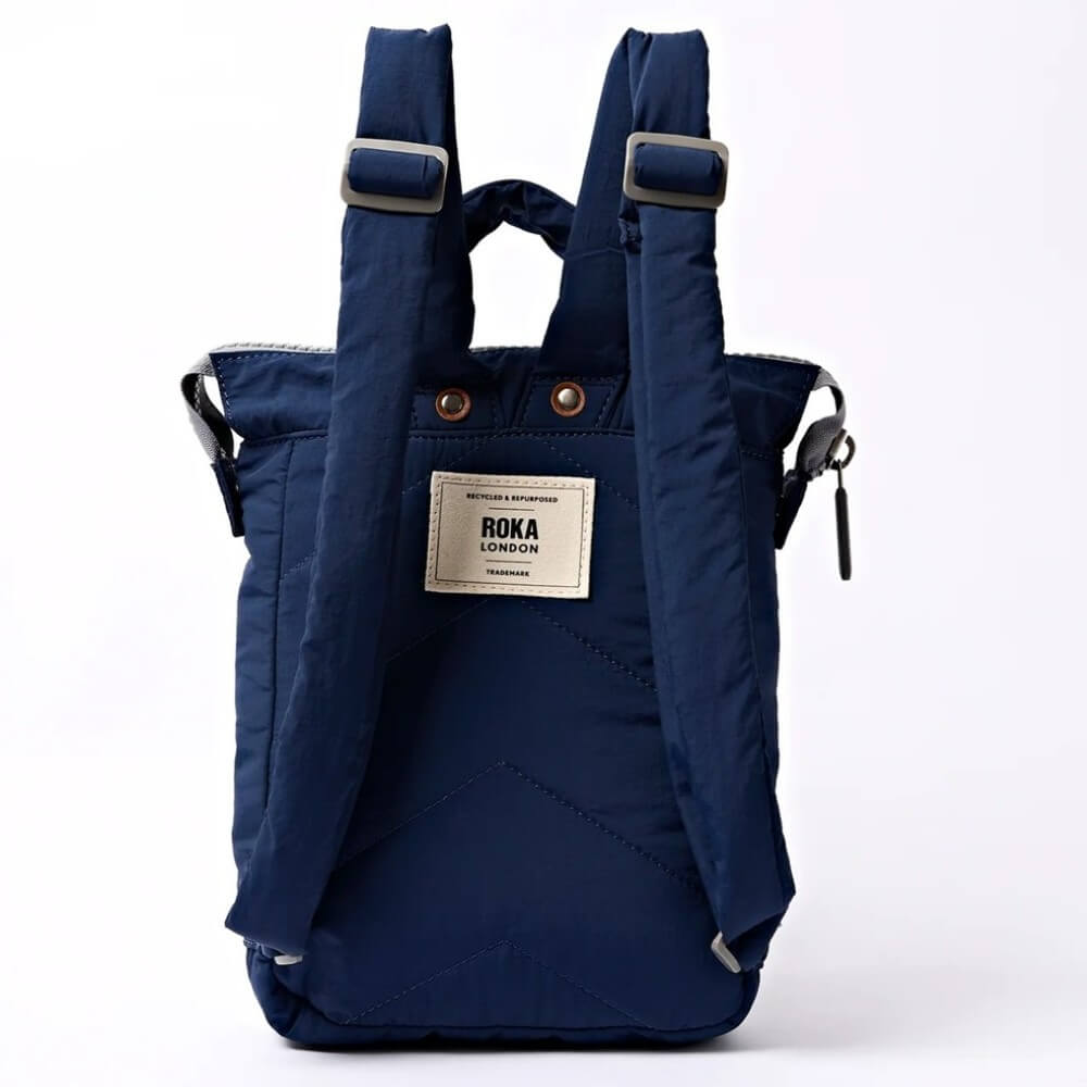 Navy blue backpack with Roka London label on a white background