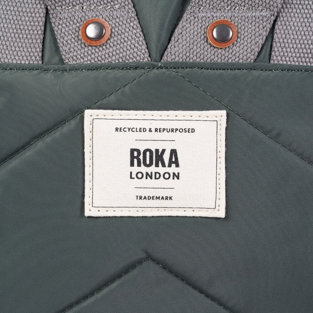 Roka London recycled and repurposed label on a gray fabric background