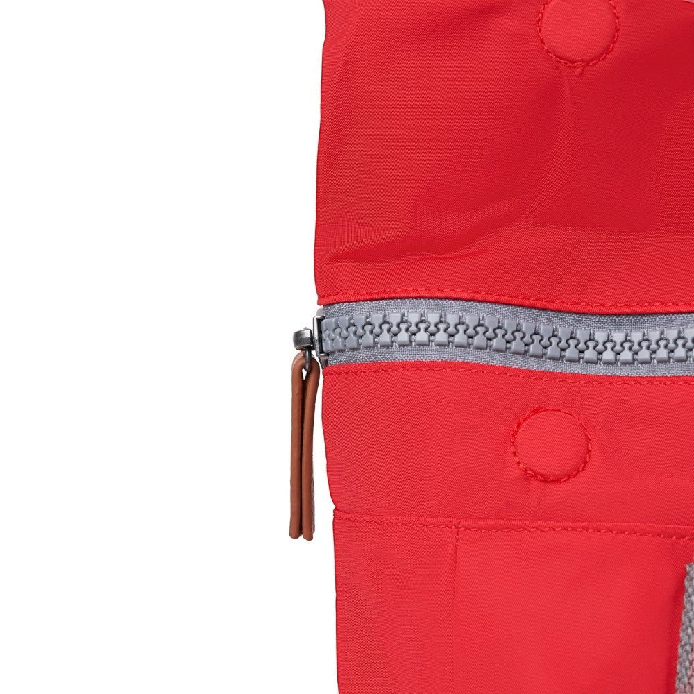 Close-up of a red jacket with a zipper on a white background
