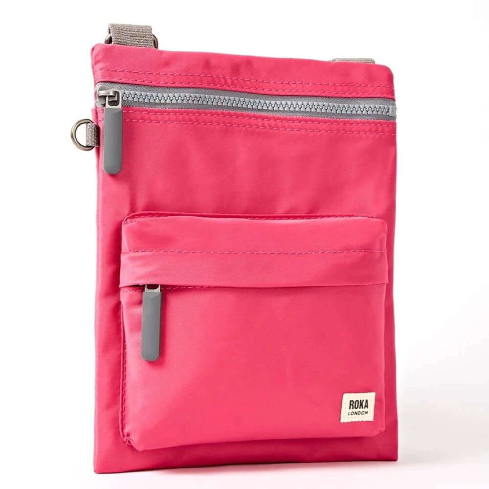 Pink Roka crossbody bag with a visible brand label on a white background