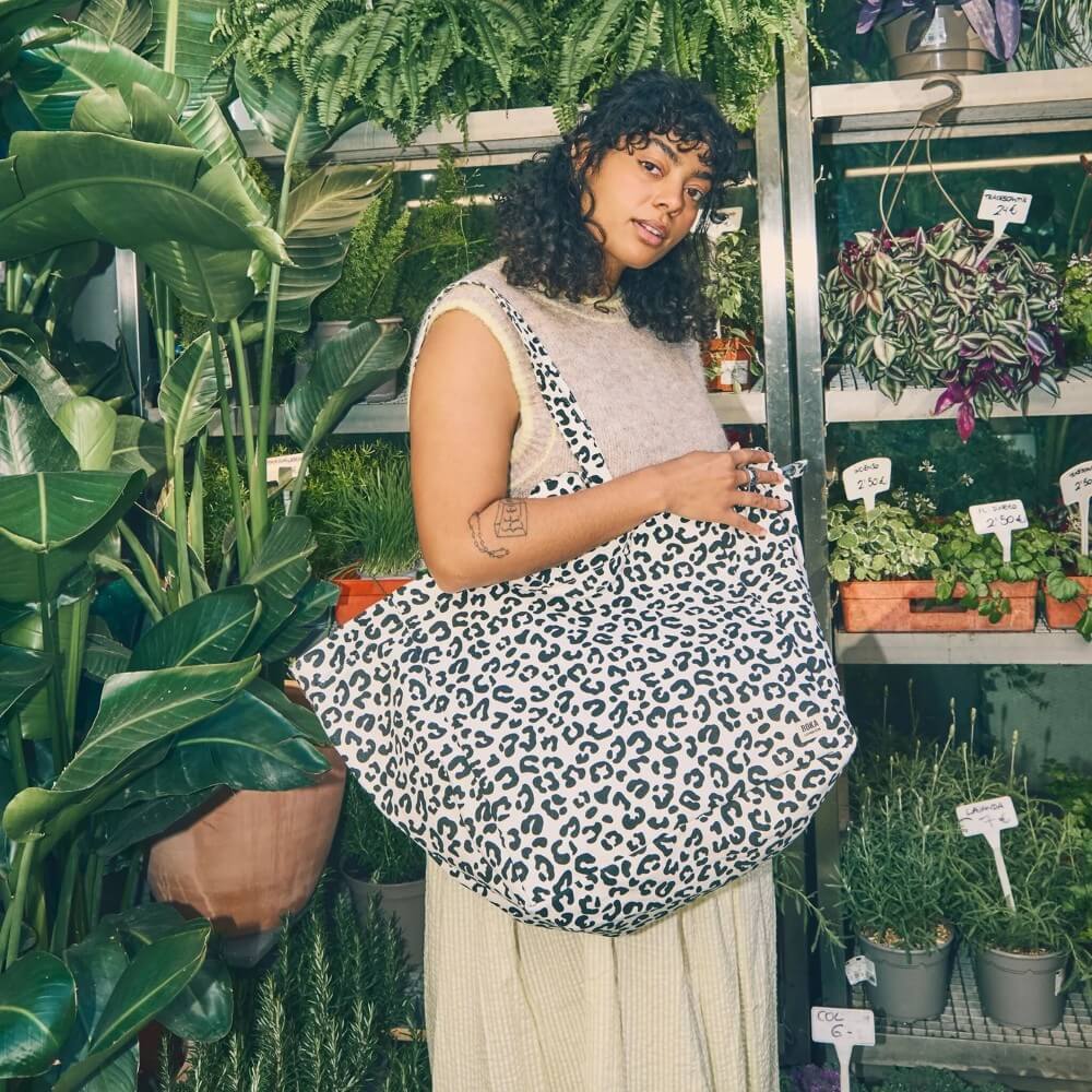 person with Roka leopard print tote bag at garden centre