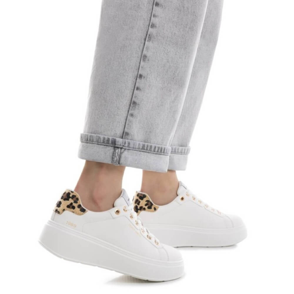 White sneakers with leopard print accents worn with light gray jeans on a white background Teddy Smith Sneakers 120264 White Leopard