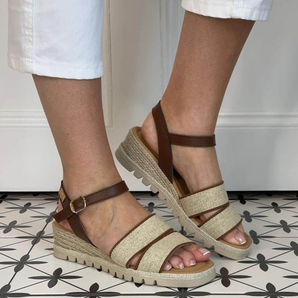 Toni Pons Brown and beige sandals worn with white pants against a neutral background