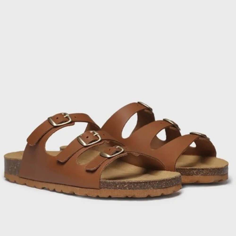 Pair of Toni Pons brown sandals with buckles on a light grey background