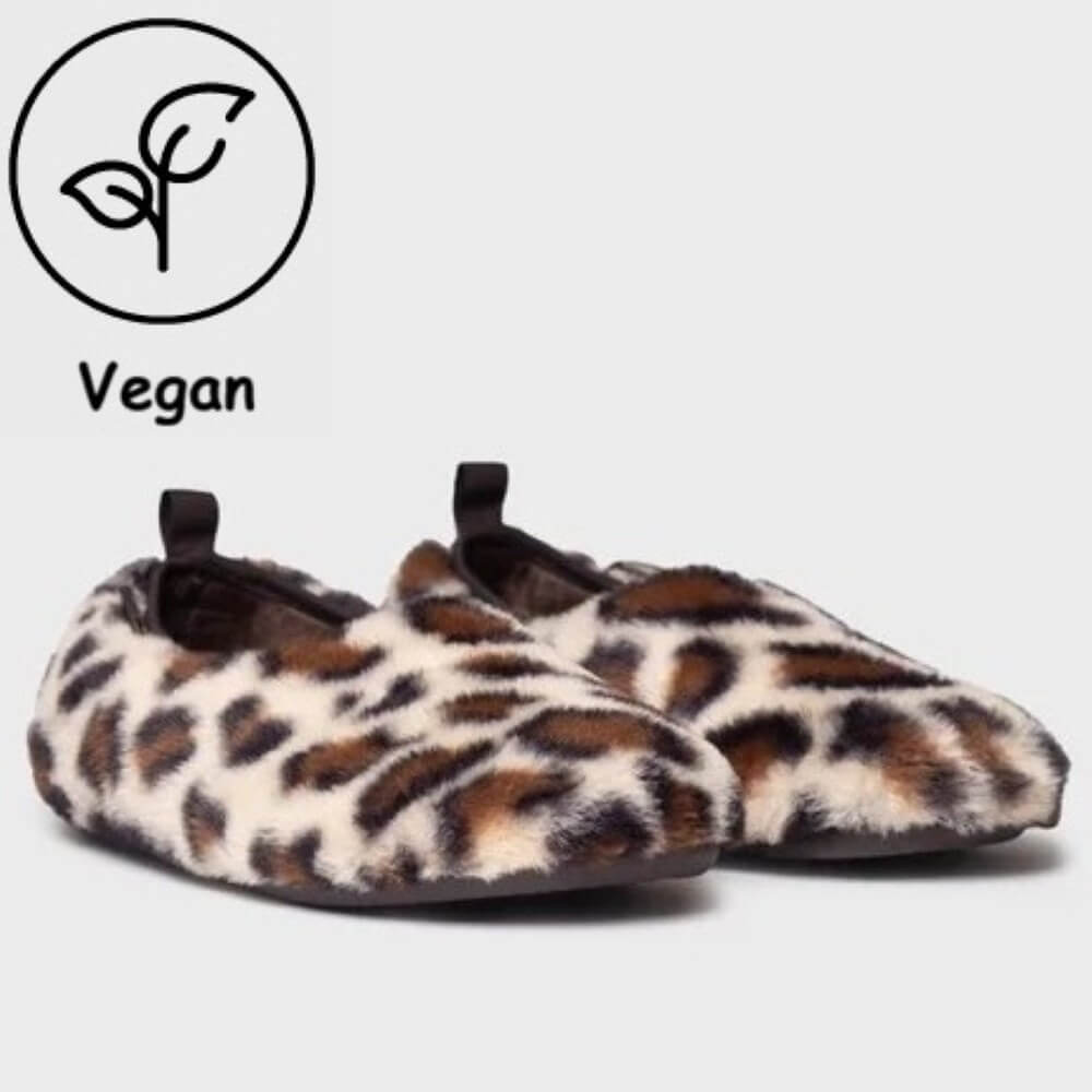 Toni Pons Leopard print faux fur slip-on slippers shown on a light grey background with a 'Vegan' leaf icon overlay in the top-left corner.