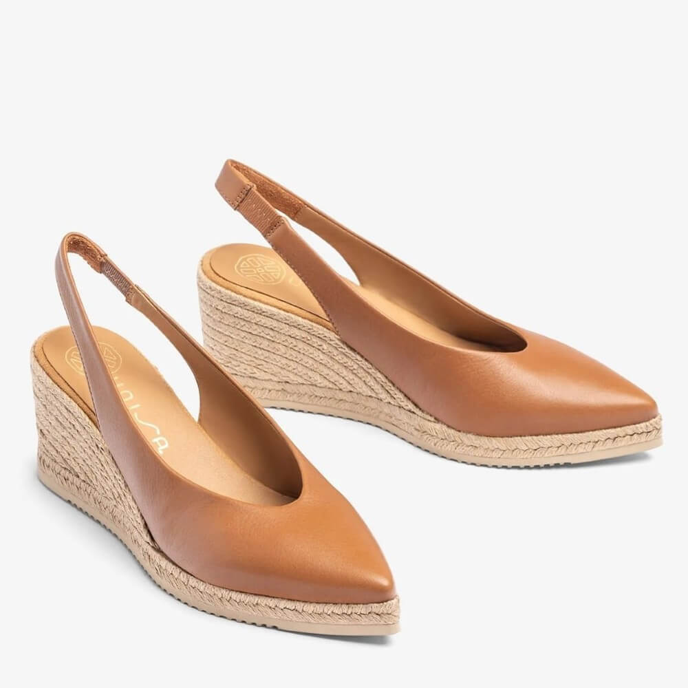 Pair of Unisa Tan wedge sandals with espadrille sole on a light grey background