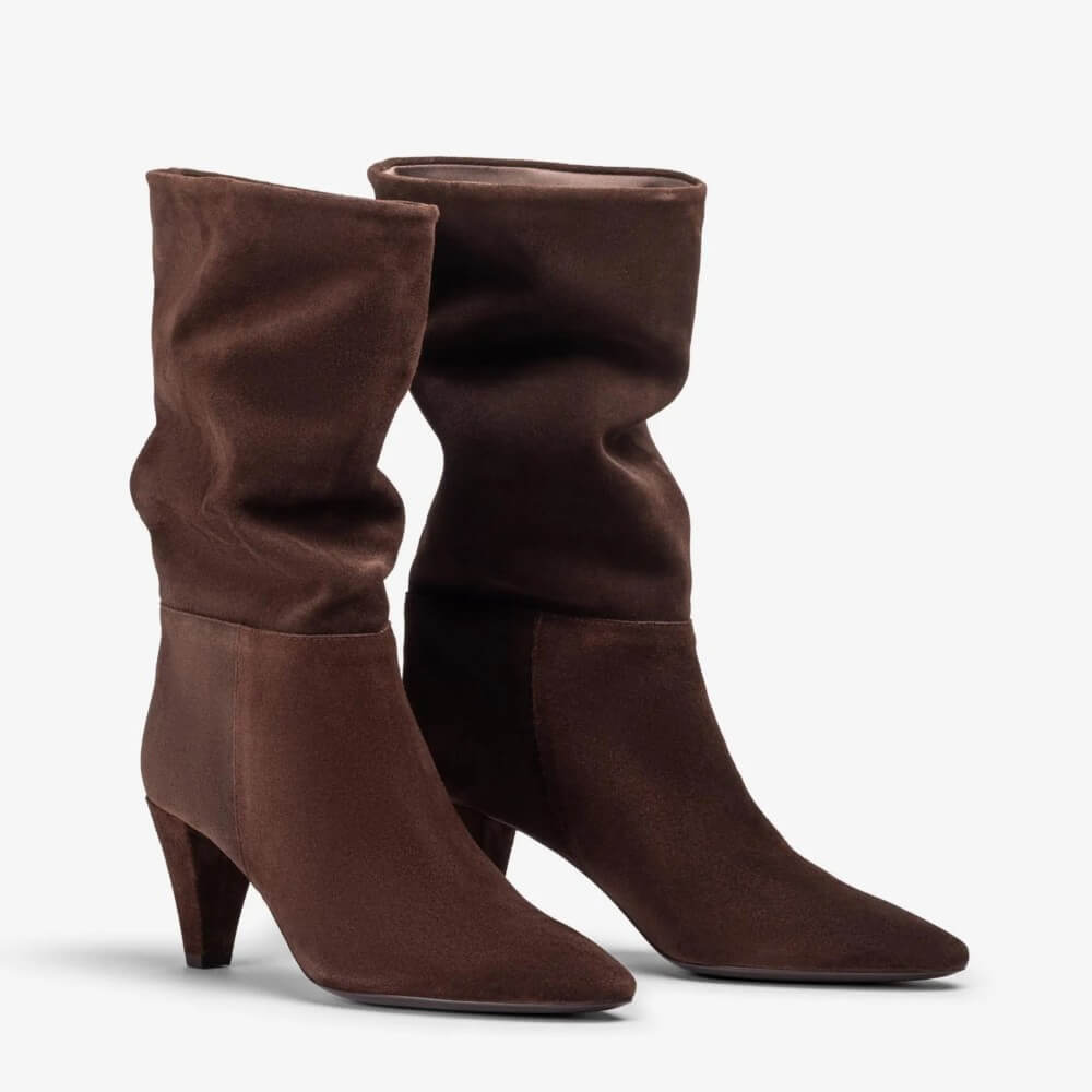 A pair of Unisa dark brown suede mid-calf boots with pointed toes and kitten heels, shown against a plain light grey background.