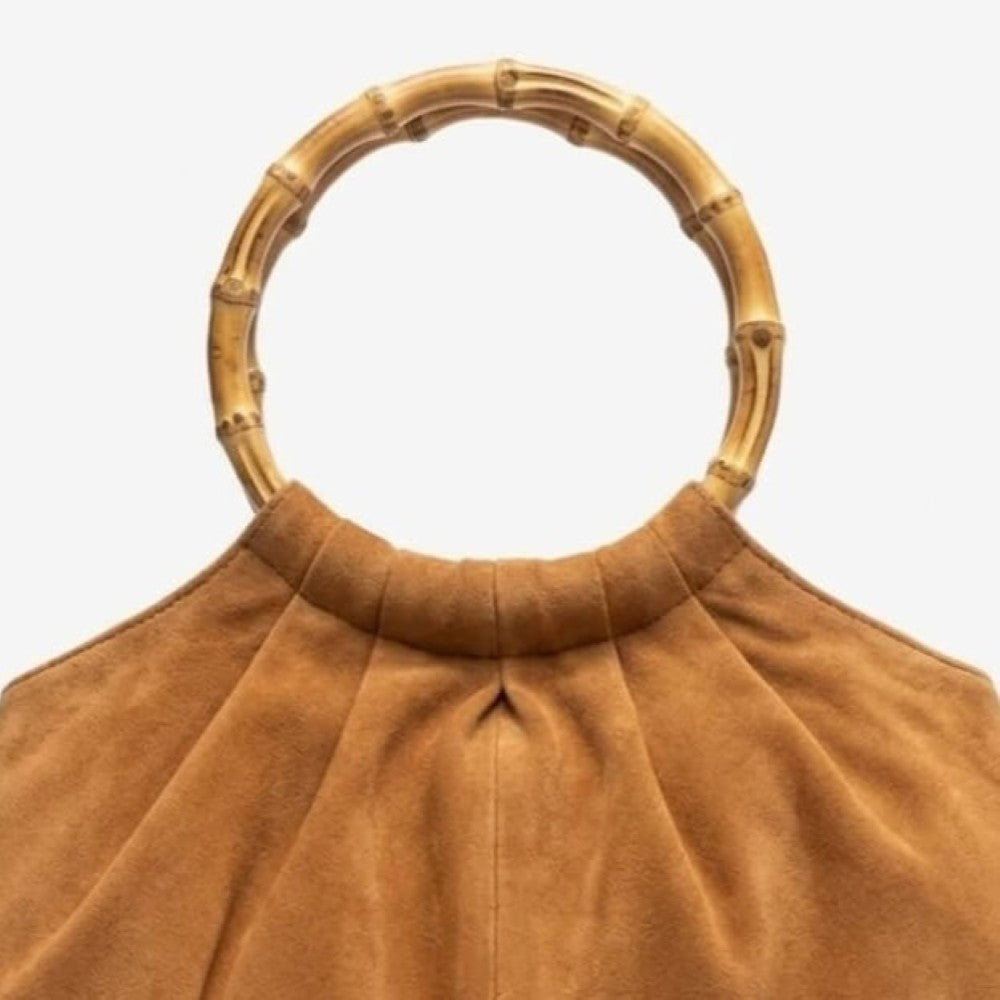 Brown handbag with bamboo handle on a white background