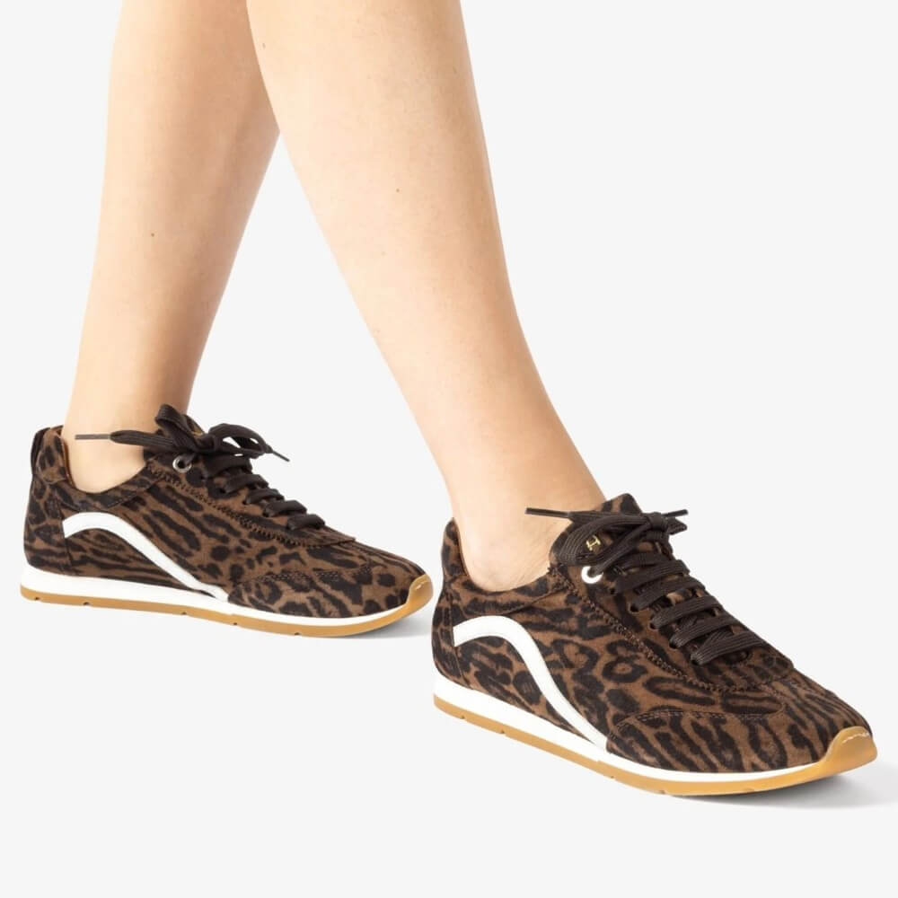 Leopard print sneakers worn by a person on a white background Unisa Dalai Suede Trainer Leopard