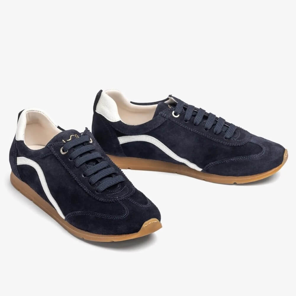 Pair of navy blue sneakers with white accents on a light Gray background Unisa Dalai Suede Trainer Navy