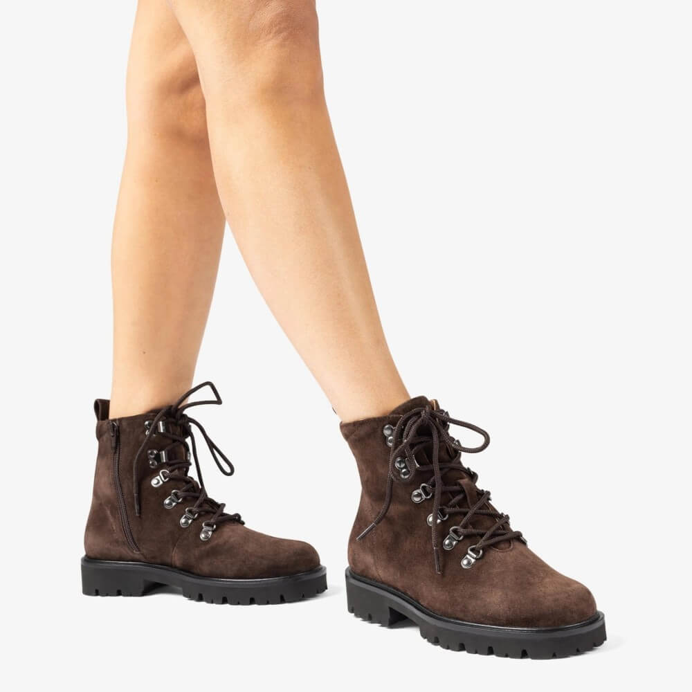 Brown lace-up boots worn by a person on a white background Unisa Fiela Suede Leather Ankle Boot Brown