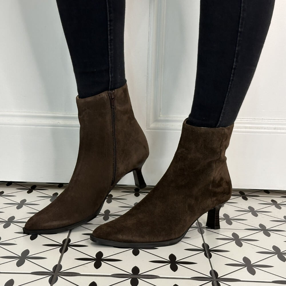 Brown Suede Heel Ankle Boots worn with black leggins on a pattern floor