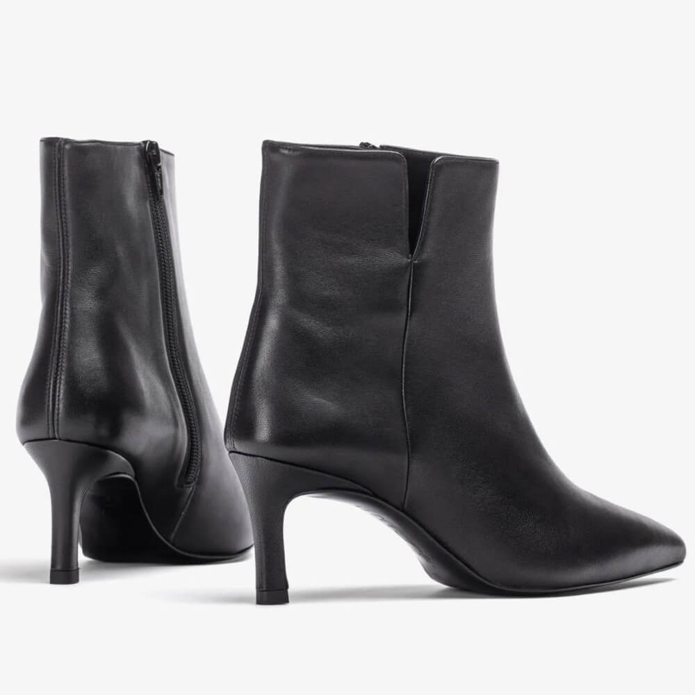 Black high-heeled ankle boots on a light gray background Unisa Loroya Pointed Toe Leather Ankle Boot Black