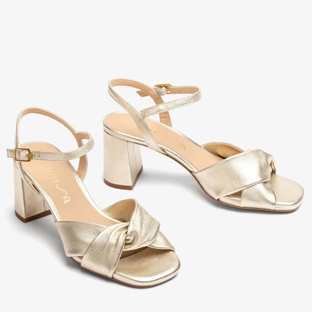 Gold metallic sandal with a block heel on a white background. unisa medway