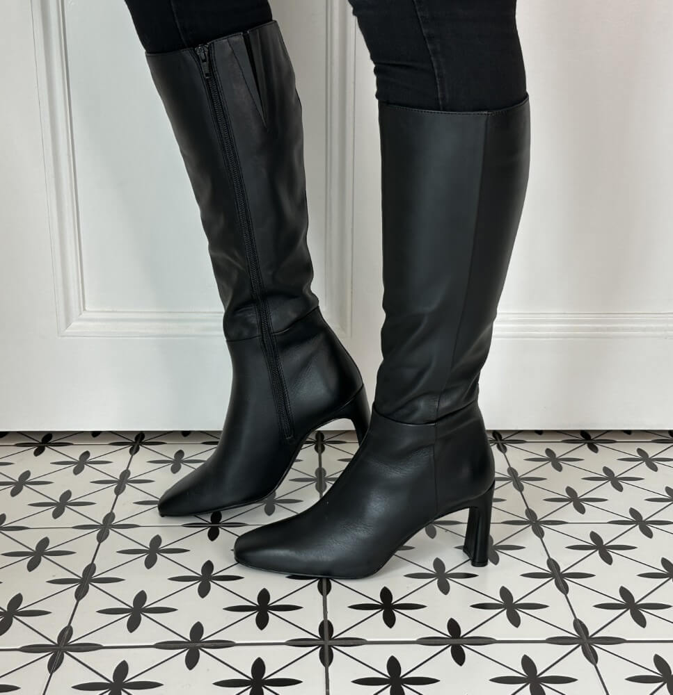 Black knee-high boots on a patterned floor Unisa Wolcot Leather Knee High Boot Black
