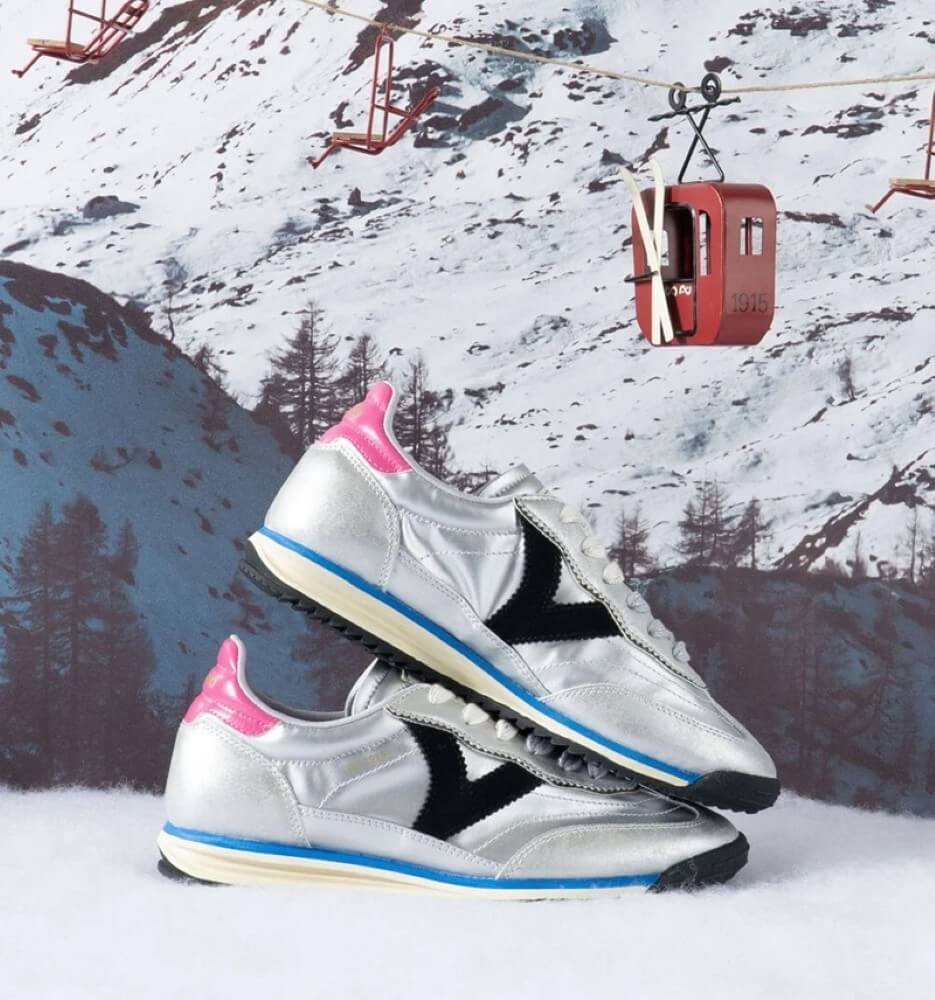 Silver sneakers with pink and black accents on a snowy mountain background with ski lift. Silver sneaker with pink and black accents on a white background VICTORIA SATURNO Sneakers 1158102 SILVER
