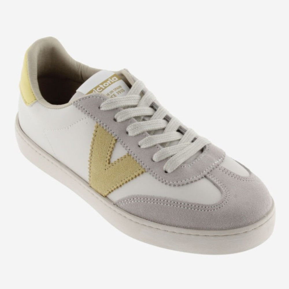 Victoria beige  and white sneaker with yellow accents on a white background