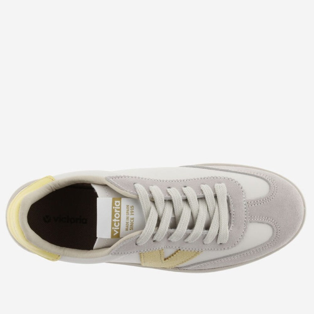 Victoria beige  and white sneaker with yellow accents on a white background