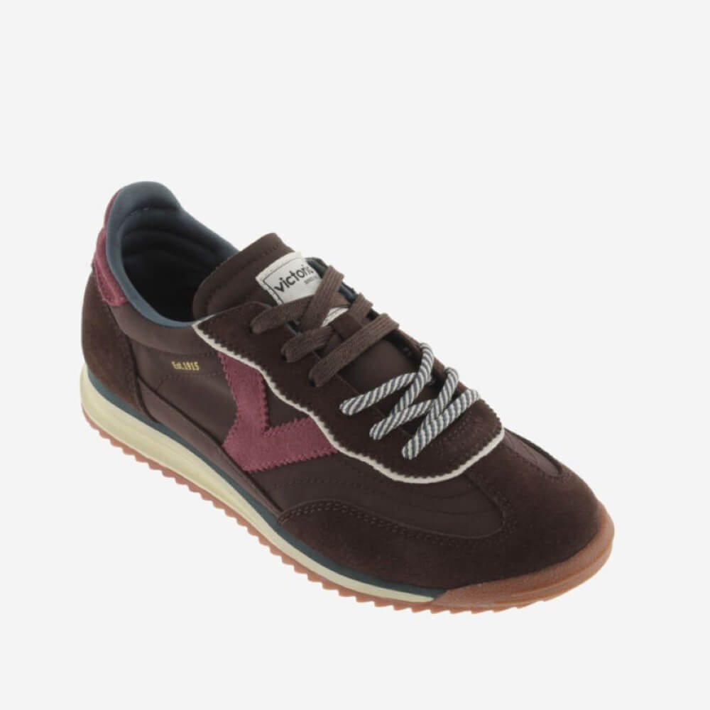 A dark brown suede Victoria sneaker with burgundy overlays, white laces, and a cream midsole on a light grey background.
