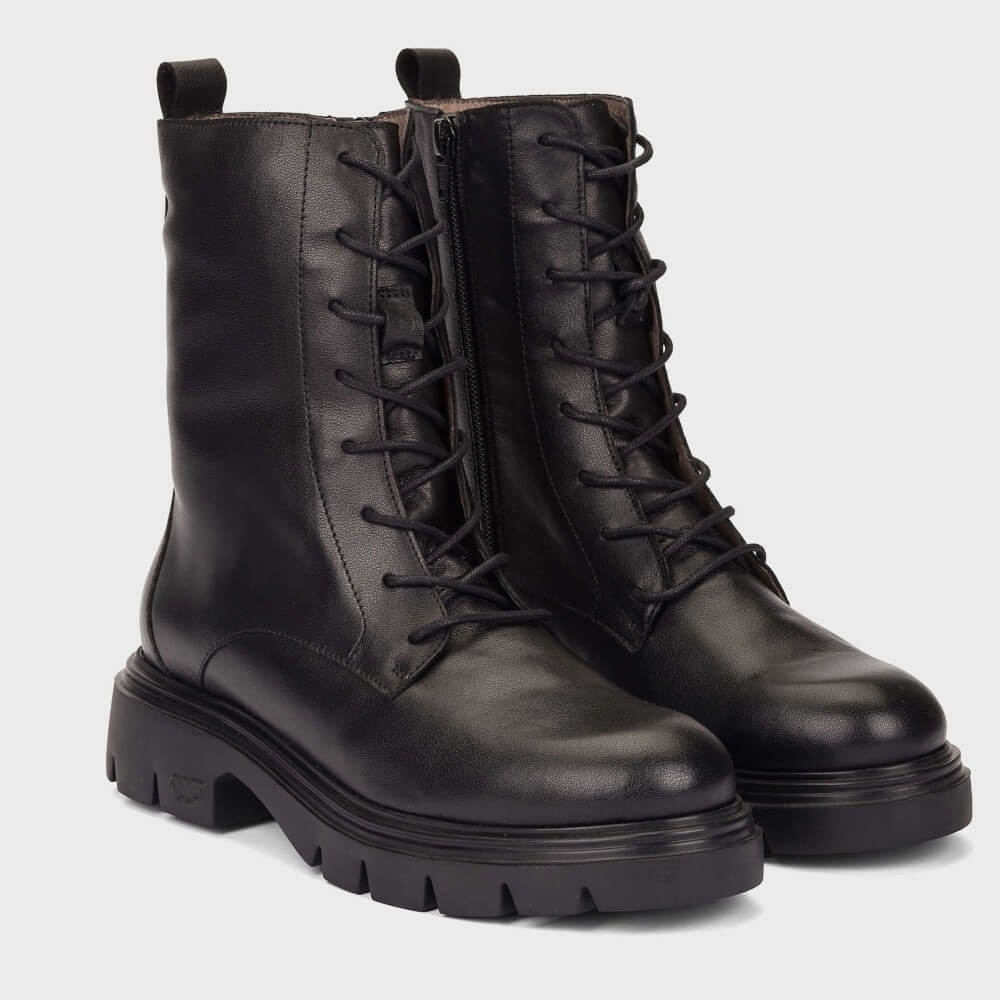 A pair of Wonders black leather lace-up combat boots with chunky lug soles, shown on a light grey background.
