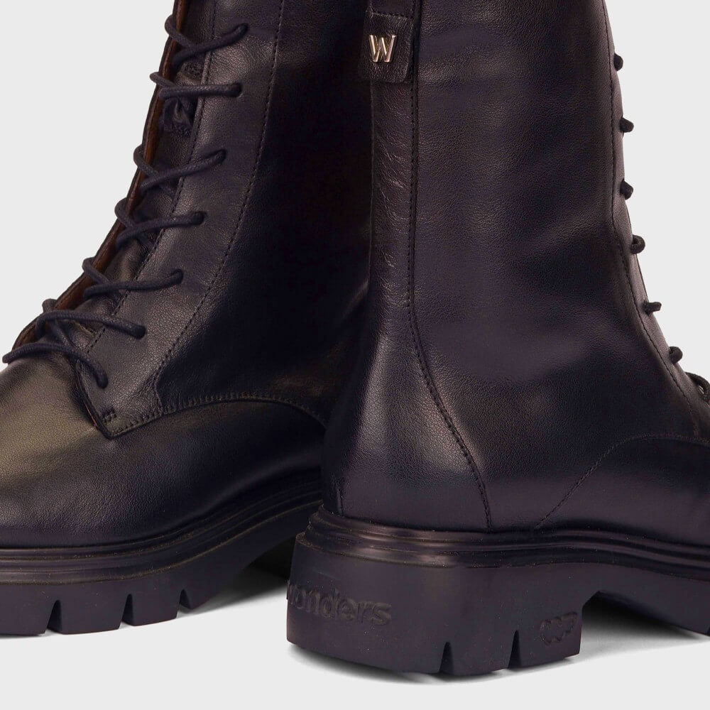 Close-up of a pair of Wonders Wine leather lace-up boots with chunky lug soles, showing the side profile and heel detail on a light gray background.