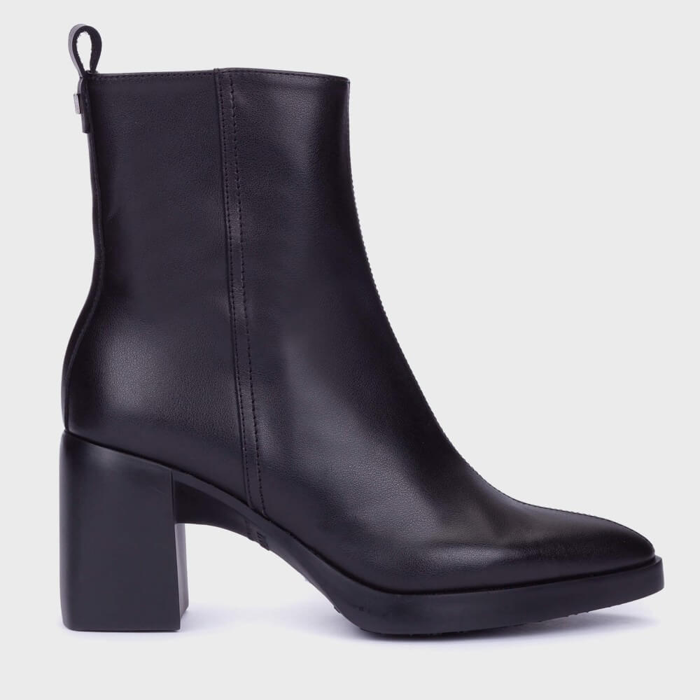 A Wonders black leather ankle boot with a chunky block heel and a small pull loop at the back, shown from a side profile on a light grey background.