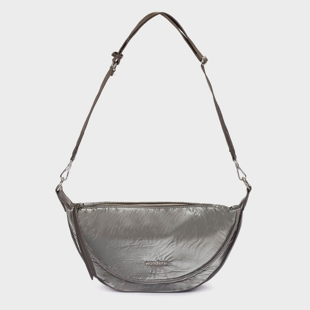 A Wonders dark gray crescent-shaped shoulder bag with a shiny, crinkled texture, featuring a wide adjustable brown fabric strap and silver hardware. The brand name 'wonders' is printed in white on the front.
