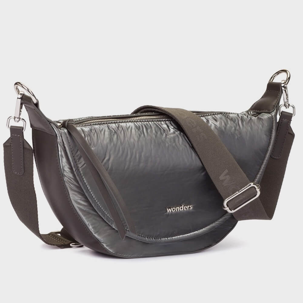 A Wonders dark gray crescent-shaped shoulder bag with a shiny, crinkled texture, featuring a wide adjustable brown fabric strap and silver hardware. The brand name 'wonders' is printed in white on the front.