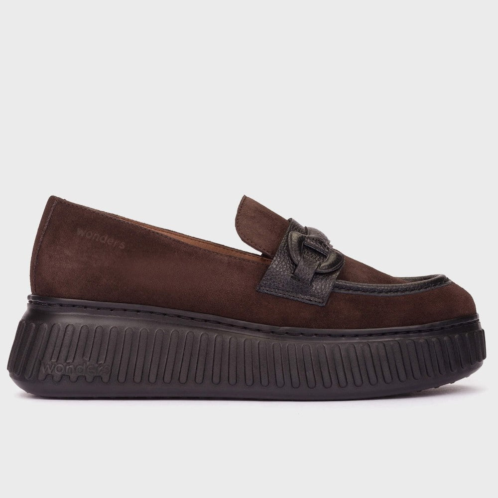 A Wonders brown suede platform loafer with a black textured sole and a decorative black strap detail on the toe, shown against a plain light grey background.