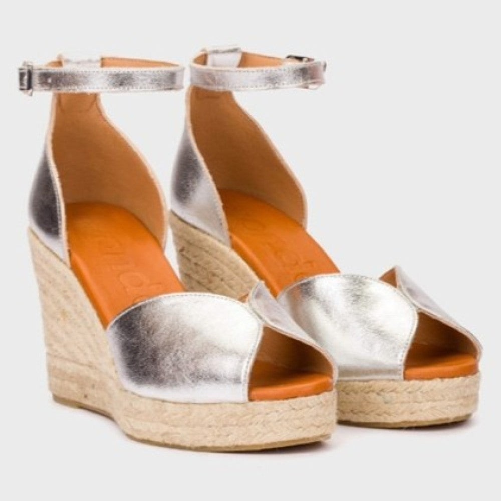 Wonders Silver wedge espadrilles with a textured sole on a light gray background
