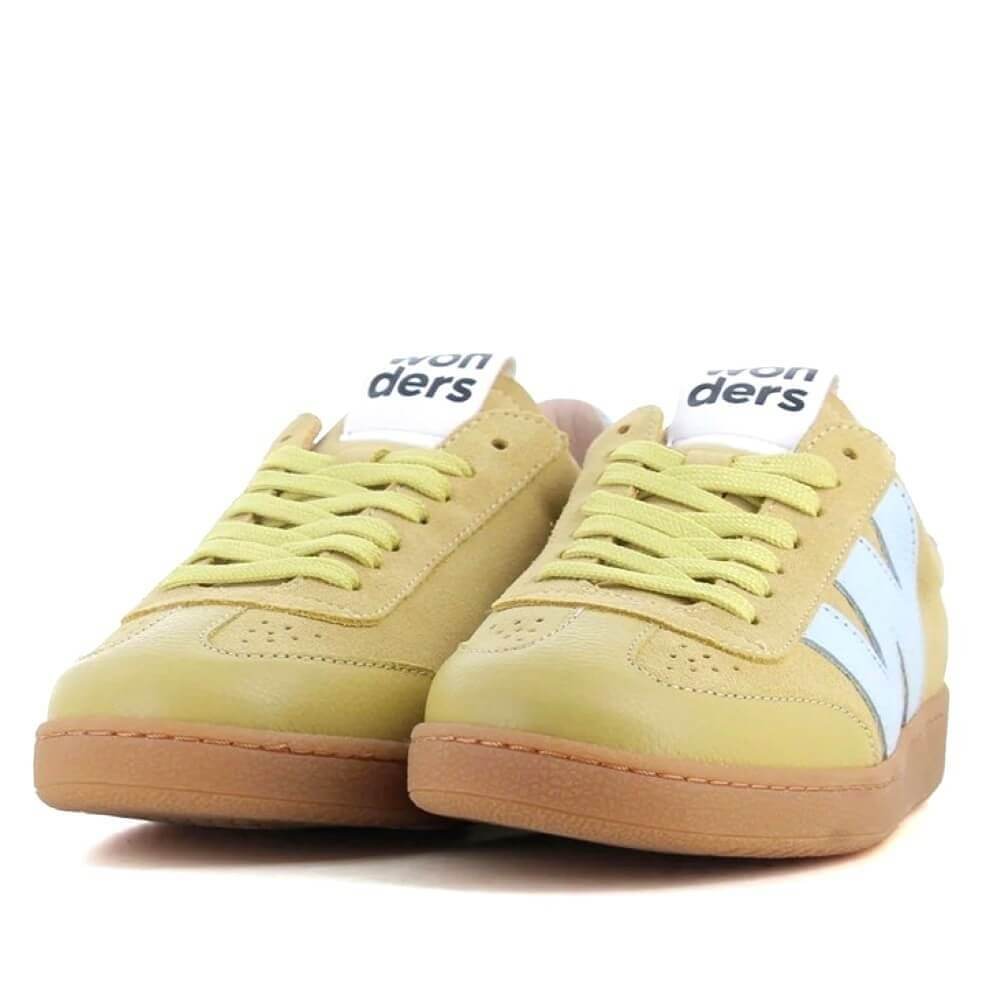 Pair of light yellow sneakers with white laces and a light brown sole on a white background.