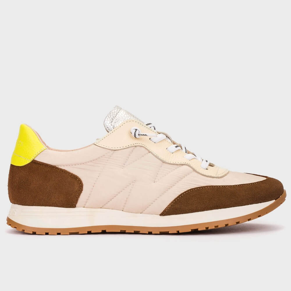 Sneaker with beige and brown design on a light gray background