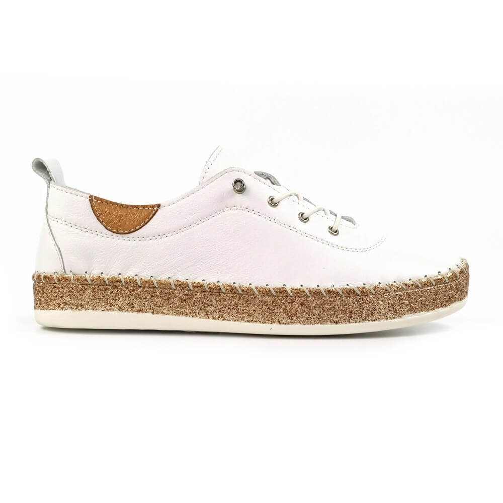 White sneaker with cork sole on a white background