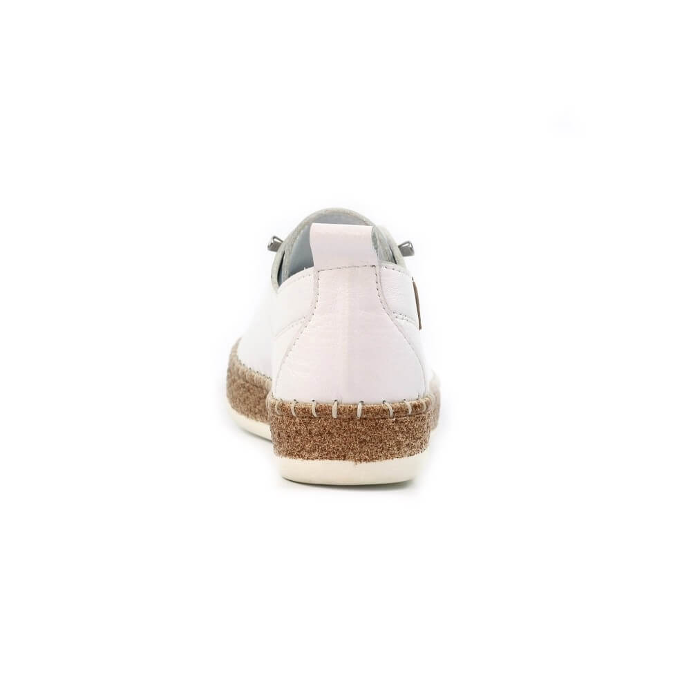 White sneaker with cork sole on a white background
