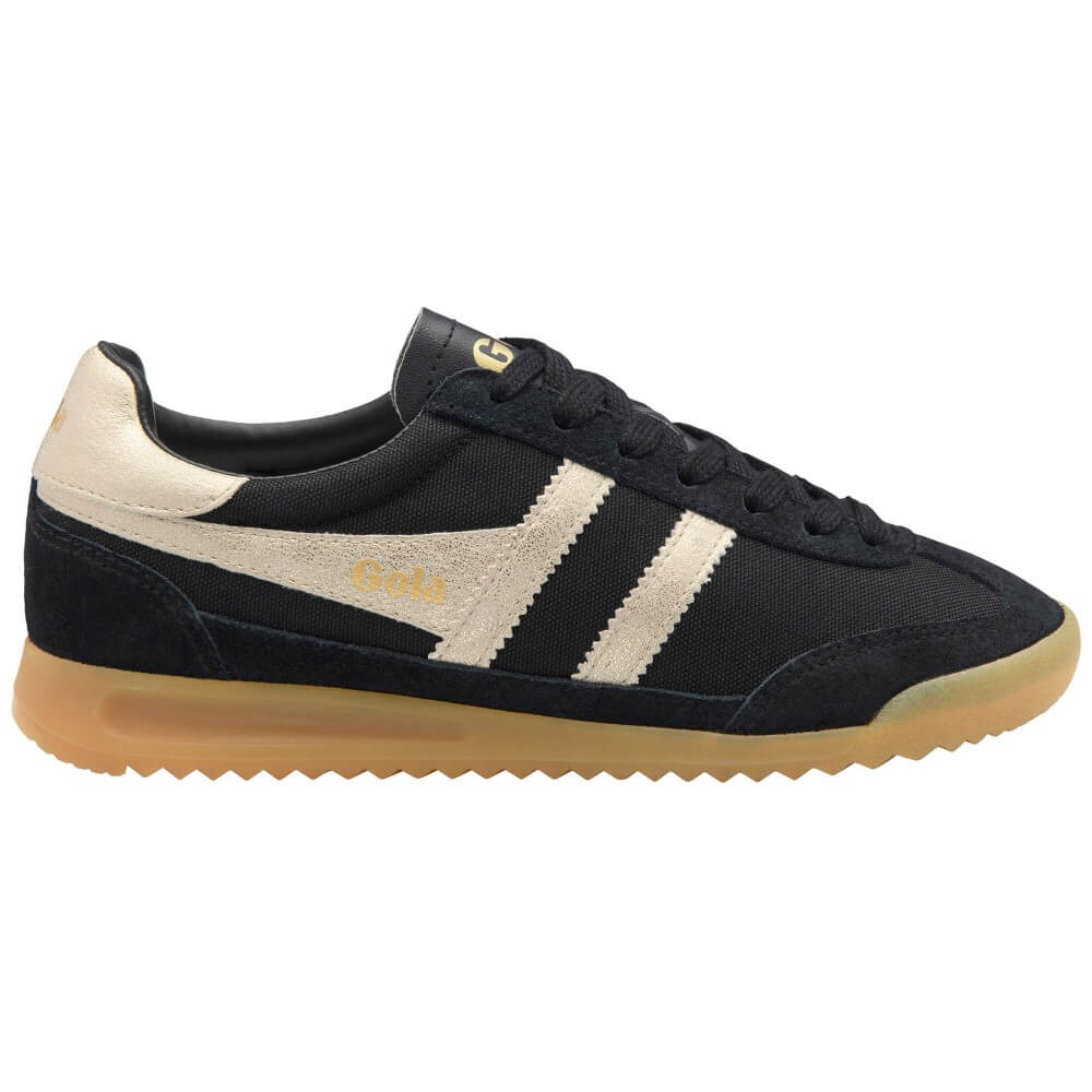 A Gola low-top sneaker in black canvas and suede with cream suede side stripes, a gold 'Gola' logo on the tongue and side, and a translucent gum sole.