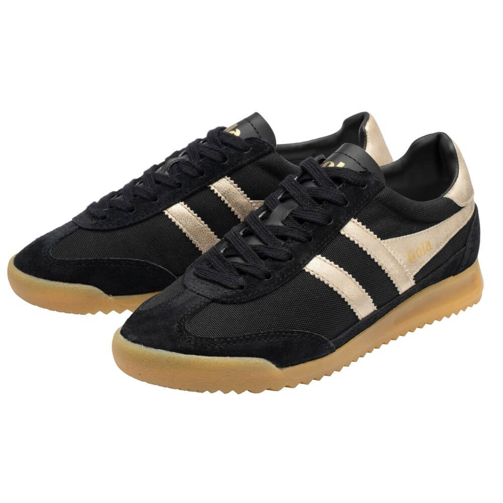 A pair of Gola low-top sneakers in black canvas and suede with cream suede side stripes, a gold 'Gola' logo on the tongue and side, and a translucent gum sole.