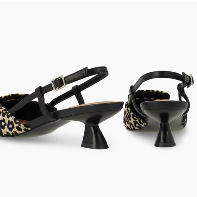 Lodi Black high-heeled shoes with leopard print soles on a white background