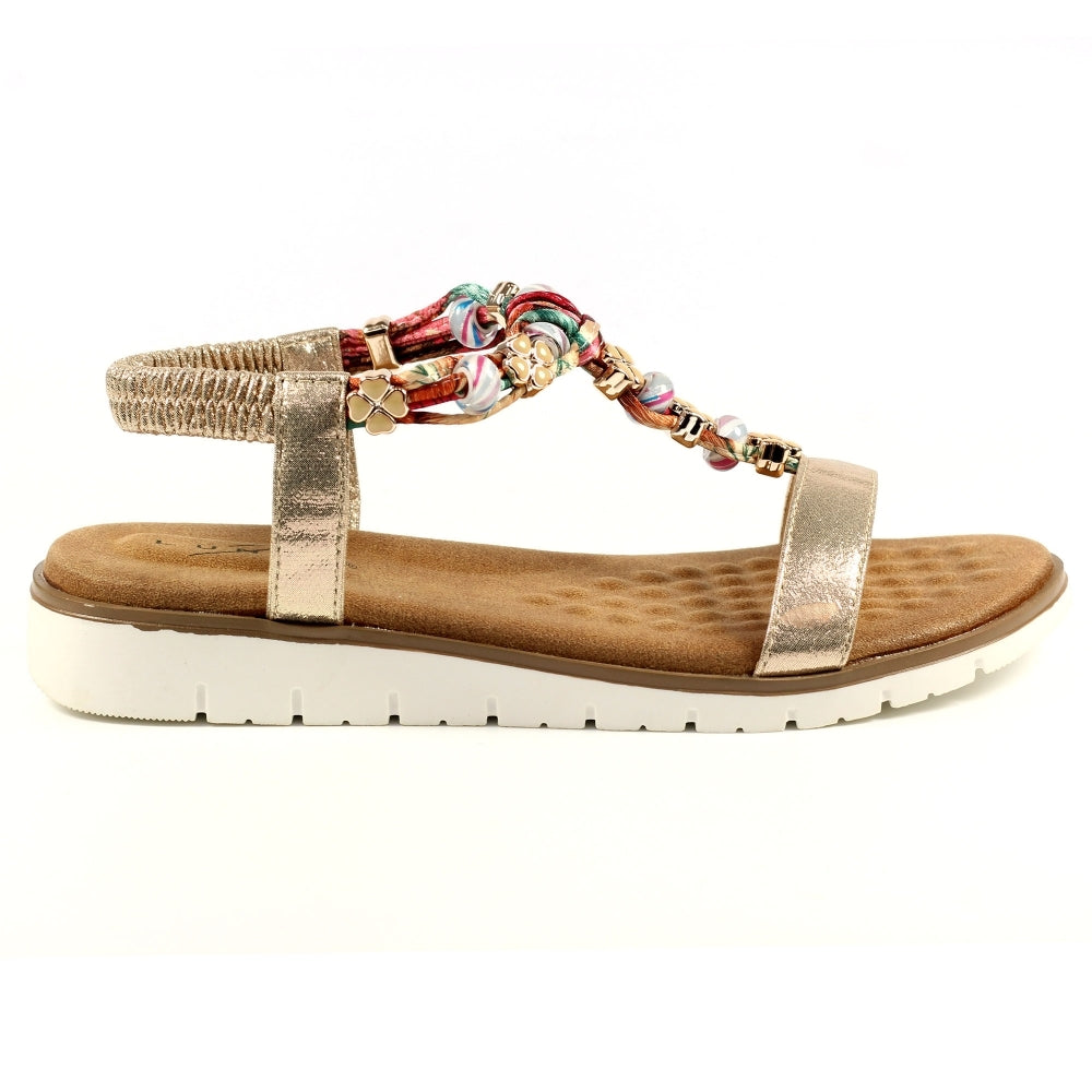 Lunar Gold sandal with a decorative strap on a white background