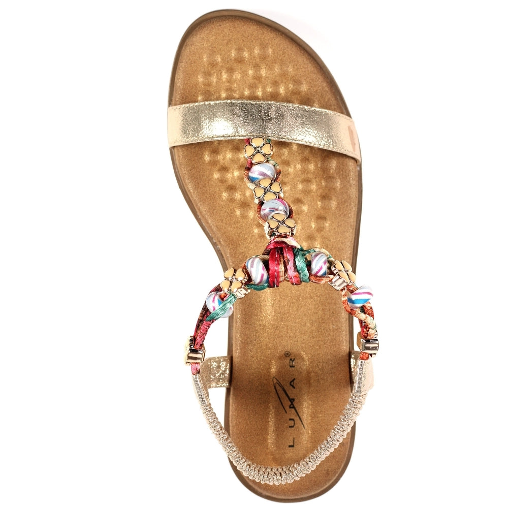 Lunar Gold sandal with a decorative strap on a white background