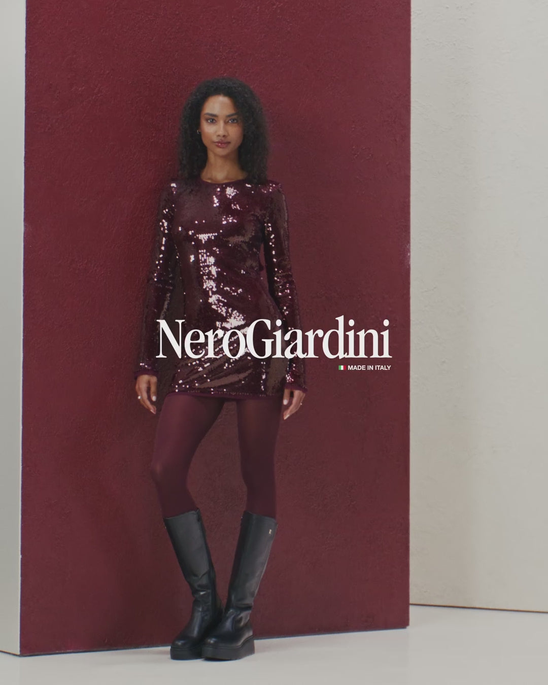 Black knee-high boots worn with burgundy tights on a neutral background   NeroGiardini Knee High Leather Boots I514902D