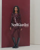 Black knee-high boots worn with burgundy tights on a neutral background   NeroGiardini Knee High Leather Boots I514902D