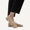 video of Caprice Beige woven flats worn with Blue jeans on a white background
