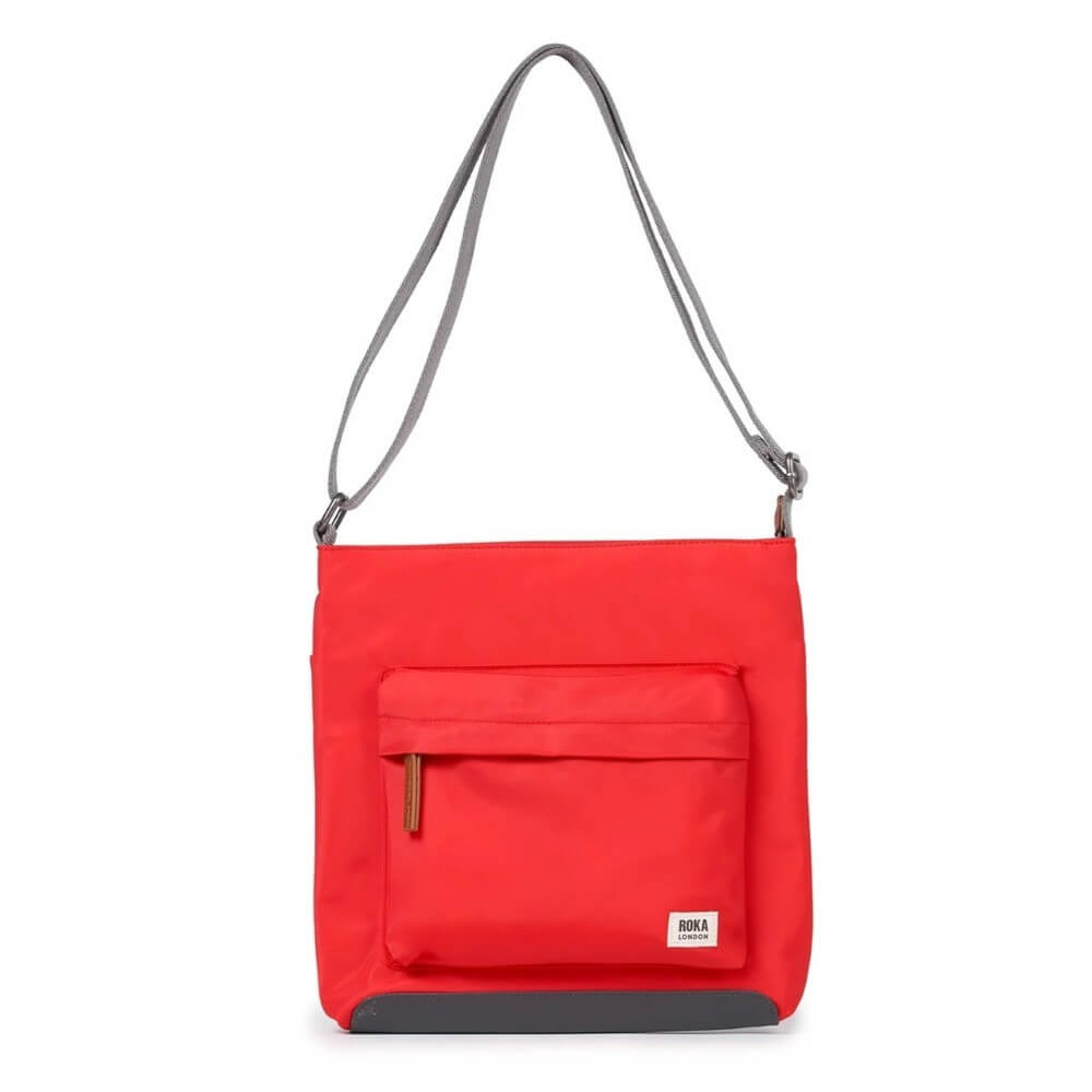 Red shoulder bag with a strap on a white background Roka