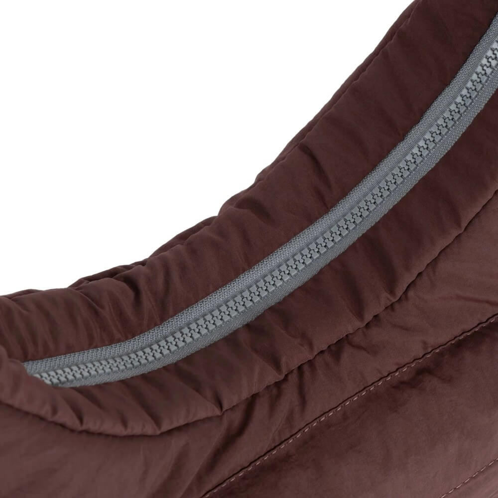 Close-up of a brown jacket with a gray zipper on a white background